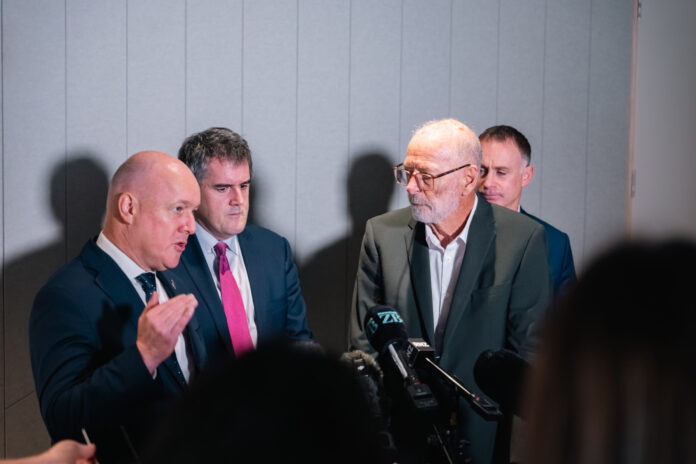 Christopher Luxon signing the Auckland Deal alongside Wayne Brown and Chris Bishop