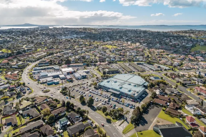 Aerial view of Meadowlands Shopping Centre surrounded by Howick housing with Rangitoto in the distance