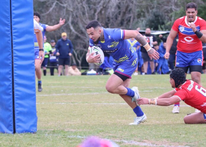 A Howick Hornets player in blue and yellow runs for the corner past a diving Otara Scorpions defender